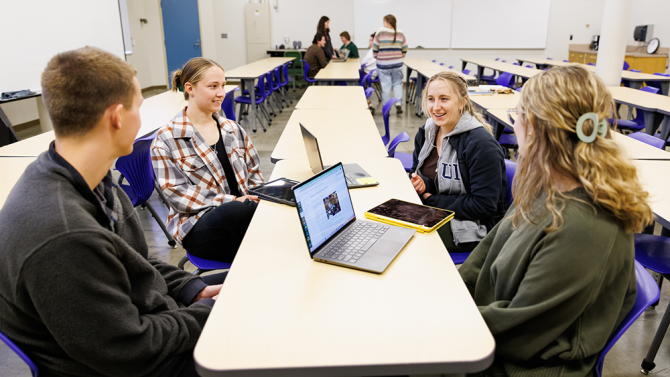 students talking in a classroom